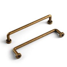 two antique brass cabinet handles on a white background with clippings to each side