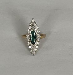 Marquise ring in yellow gold (18k) centered on a natural navette-cut emerald of approximately 1.00 ct in a surround of natural brilliant-cut diamonds. Total weight of diamonds: approximately 1.00 ct. Plate: 30 x 12 mm. Gross Weight: 8.90 g. Size: 55 Possibility of sizing, contact us. Further information : We issue an invoice as well as a certificate of authenticity established by our qualified gemologist (LFG Paris). Our photos are not reworked and are taken in a natural light environment. We ca Marquise Ring, Multi Stone Ring, Emerald Diamond, Multi Stone, Emerald Ring, Brilliant Cut Diamond, Yellow Gold Rings, Stone Rings, Natural Light