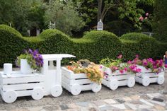 there is a small train made out of flowers