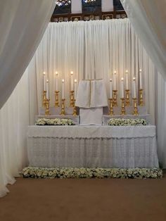 the altar is decorated with candles and flowers