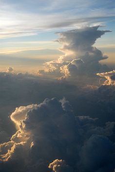 the view from an airplane looking down at clouds