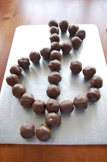 some chocolate balls are arranged in the shape of a snowflake on a cutting board