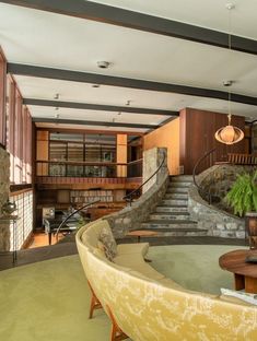 a living room filled with furniture next to a staircase