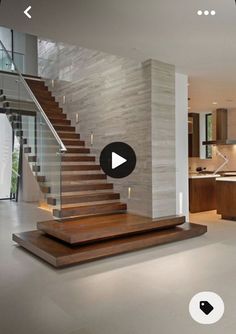 an open floor plan with stairs leading up to the kitchen