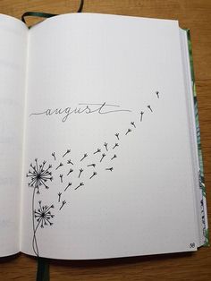 an open notebook with a dandelion drawn on the page and writing in cursive ink