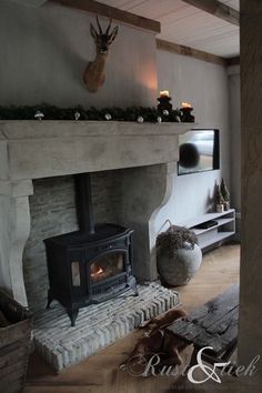 a living room with a fire place next to a tv on a wall above a fireplace