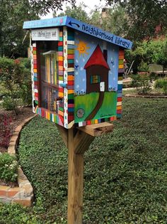 a colorful mailbox with a house painted on it