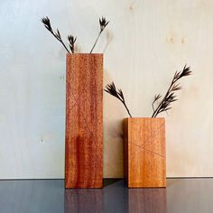 two wooden vases sitting on top of a table