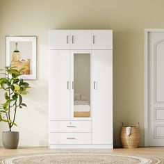 a room with a white cabinet and a potted plant on the floor next to it