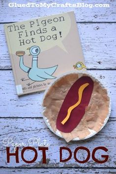 a paper plate with a hot dog on it and a book about the pigeon finds a hot dog