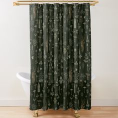 a shower curtain with an animal and plants pattern on it, hanging in a bathroom