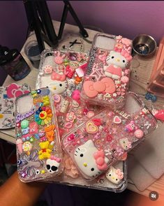 three clear cases with hello kitty on them