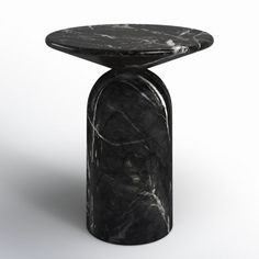 a black marble side table on white background