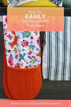 an oven mitt sitting on top of a counter next to other kitchen towels and cooking utensils