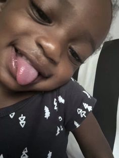 a small child sticking its tongue out