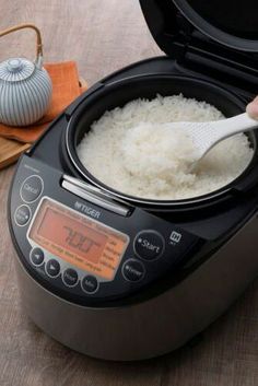 rice is being cooked in an instant pot with a digital thermometer next to it