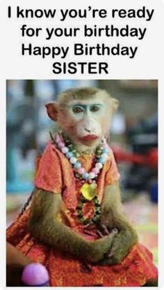 a monkey dressed up as a woman with beads around her neck