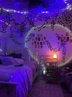 a bedroom decorated in purple and white lights