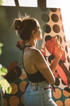 a woman standing in front of a polka dot wall