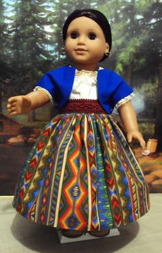 the doll is wearing a colorful dress