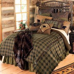 the bed is made with plaid sheets and brown pillows, along with an animal - themed comforter