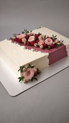 a large white cake with pink flowers on top