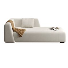 a white couch sitting on top of a white floor next to a book case and pillow