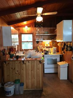 a kitchen with wood paneling and white appliances