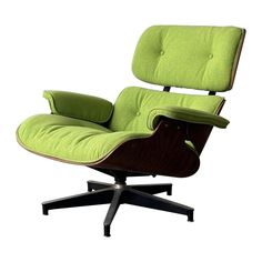 an eames lounge chair with green upholstered cushions