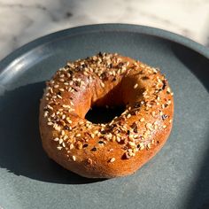 a bagel with sesame seeds is on a plate