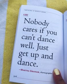 a person holding an open book in their left hand and pointing at it with the text nobody cares if you can't dance well, just get up and dance