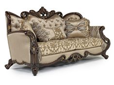 an ornately decorated couch with pillows on it's back and armrests