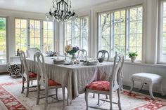 a dining room table with chairs and a chandelier