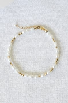 14k gold filled bracelet with 4mm-6mm freshwater pearls and 2.5mm gold filled beads Comes with an attached 1" extender chain! If you would like a different length that is not listed, please contact us for a custom order! Paired with our Mona Bracelet! Cheap Delicate Handmade Jewelry, Affordable White Beaded Bracelets With Gold Beads, Cheap Beaded Chain Bracelet For Women, Cheap Dainty Beaded Round Bracelets, Trendy Cheap Beaded Bracelets With Adjustable Chain, Affordable Dainty Beaded Bracelets With Letter Beads, Cheap Gold Bracelets With Pearl Chain, Everyday Bracelets Bead, Cheap Trendy Gold Pearl Bracelet