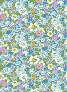 a blue and green flowered background with lots of flowers