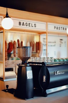 an espresso machine sitting on top of a counter in front of a bakery