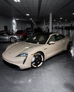 a white sports car parked in a parking garage