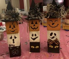 three pumpkin boxes with faces on them sitting on a table