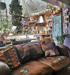 a living room filled with furniture and lots of plants in the window sill area