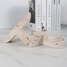 two pieces of cork sit next to each other on a table with books in the background