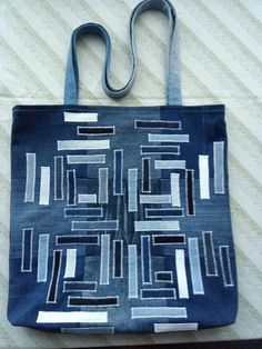 a blue bag sitting on top of a bed next to a white wall and floor