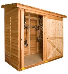 a wooden sauna with the doors open and two hooks on it's side