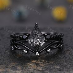 a black diamond ring with white diamonds on it