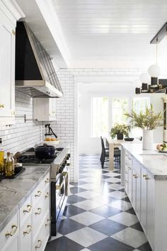 a kitchen with black and white checkered flooring