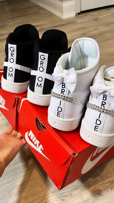 three pairs of white and black shoes are on top of a red box with the word bride written on it