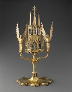 an ornate golden candelabra with angels on it