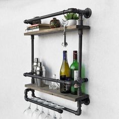 a wine glass rack with bottles and glasses on it next to a wall mounted shelf