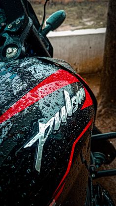 the front end of a motorcycle covered in rain