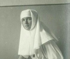 an old black and white photo of a nun