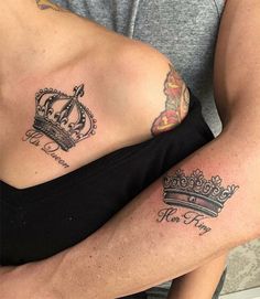 two people with tattoos on their stomachs, one has a crown and the other has a heart